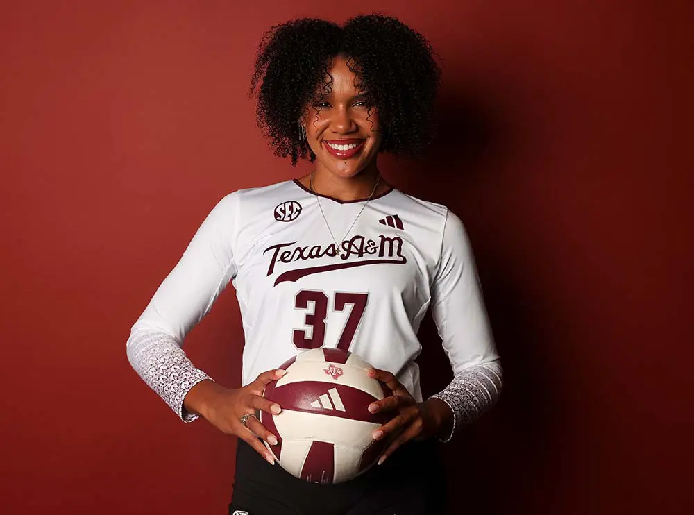 Volleyball player posing with ball