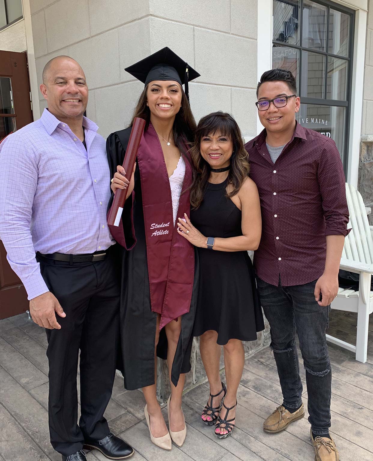 Ally Watt in her graduation gown posing with family