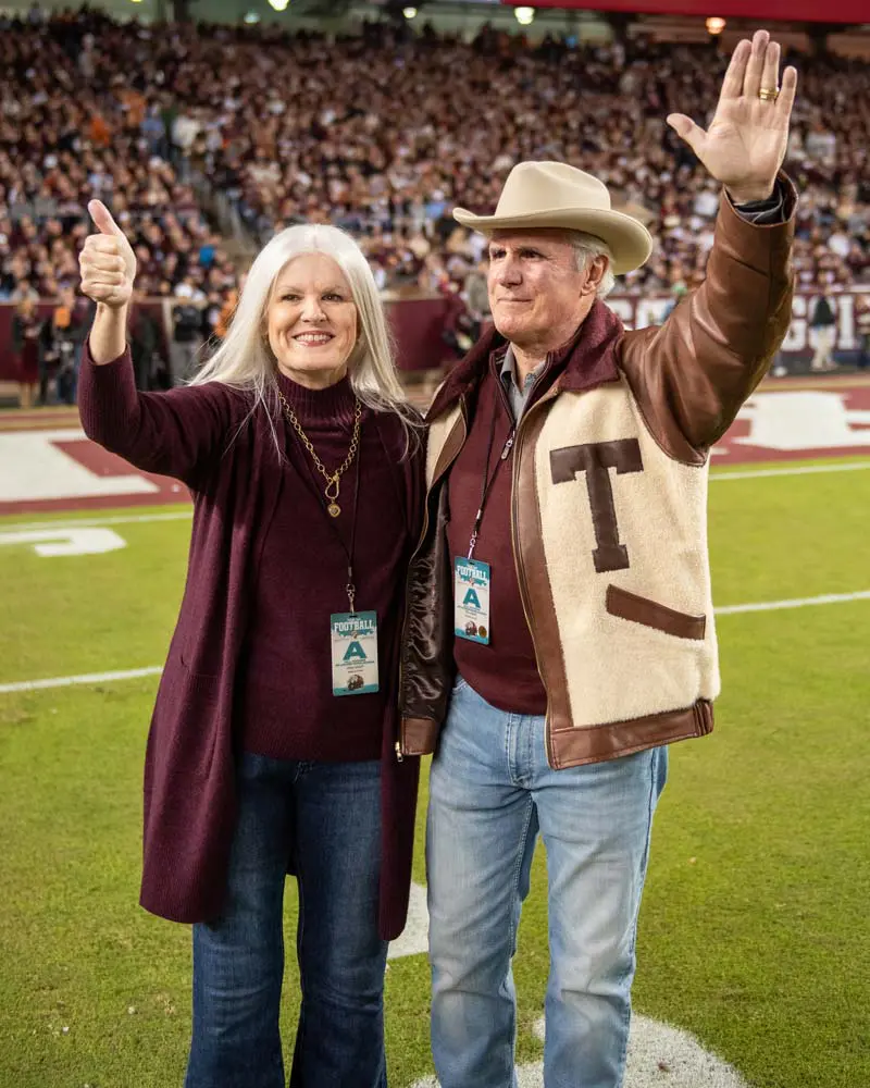 Amy and Tim Leach posing on the field