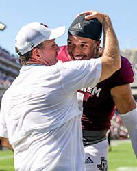 Football coach talking to player