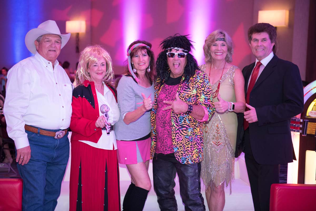 Rhonda & Frosty Gilliam Jr and others dressed in 80's attire