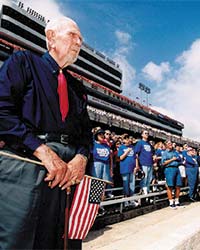 Fan standing with american flag during sporting event